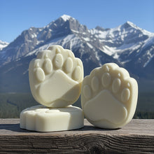 Load image into Gallery viewer, Three bear paw-shaped soap bars on a wooden surface with mountains in the background
