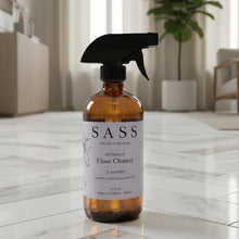 Load image into Gallery viewer, SASS floor cleaner bottle on a marble floor with a modern living room in the background

