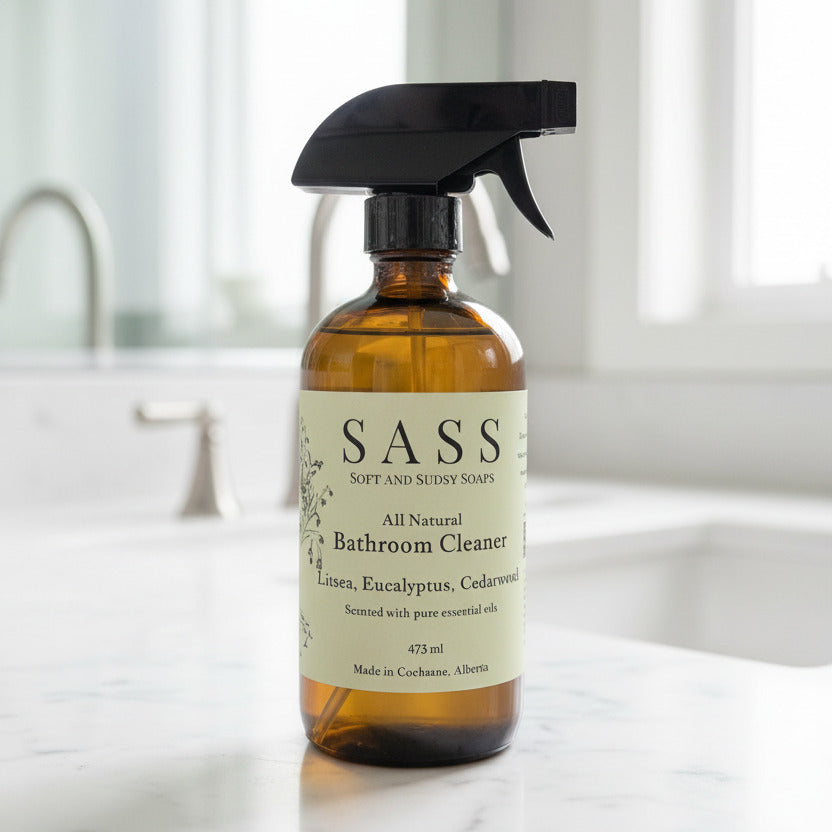 Bottle of SASS bathroom cleaner on a bathroom counter top. made in canada, all natural, non toxic cleaner 