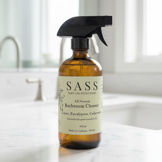 Bottle of SASS bathroom cleaner on a bathroom counter top. made in canada, all natural, non toxic cleaner 