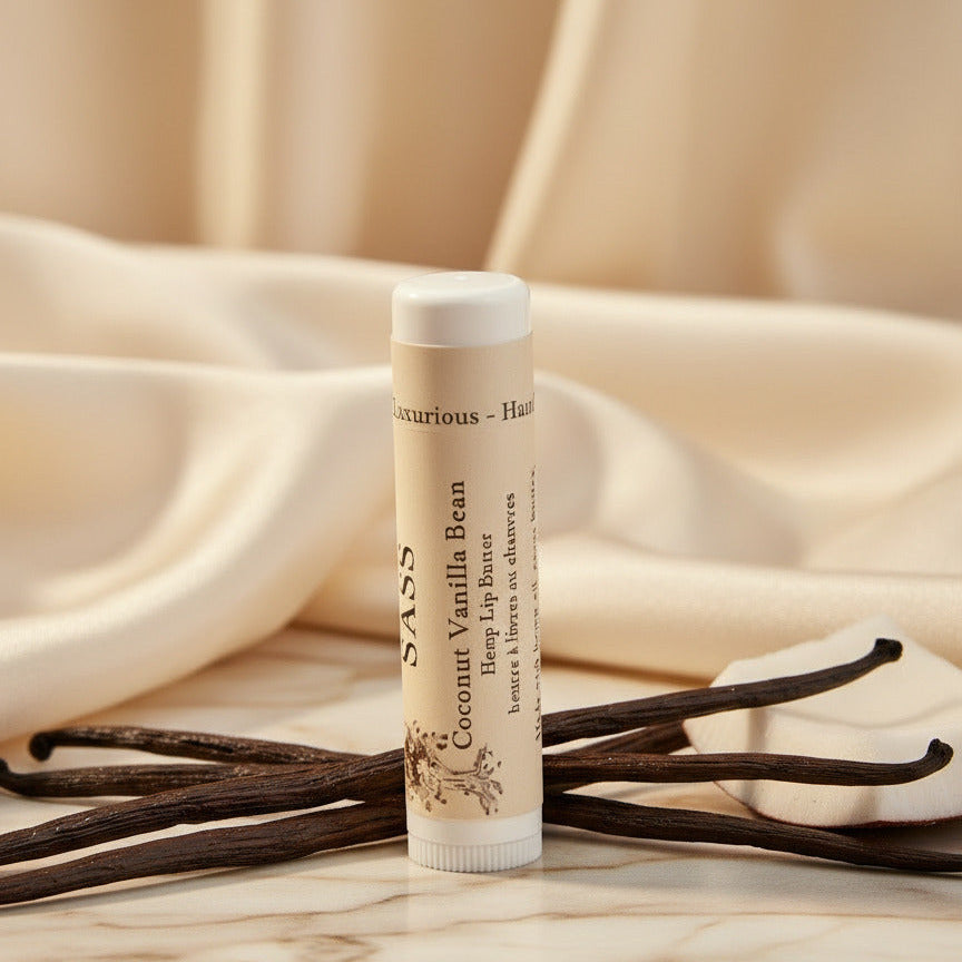 Balm tube with vanilla beans on a beige fabric background