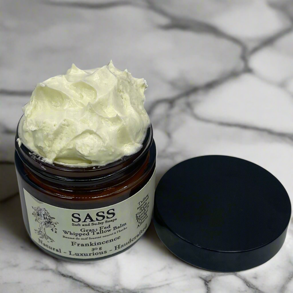 Jar of TALLOW with a black lid on a marble surface, featuring the brand 'SASS'.