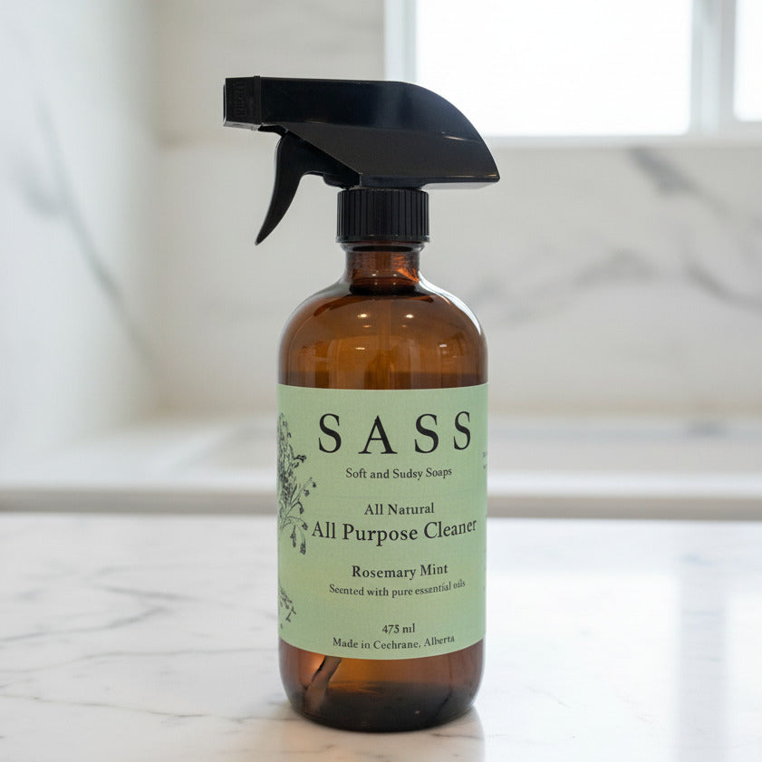 Brown spray bottle with SASS label on a marble surface