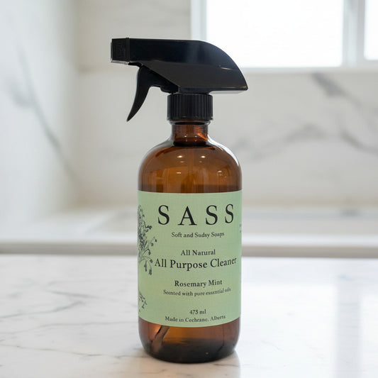Brown spray bottle with SASS label on a marble surface